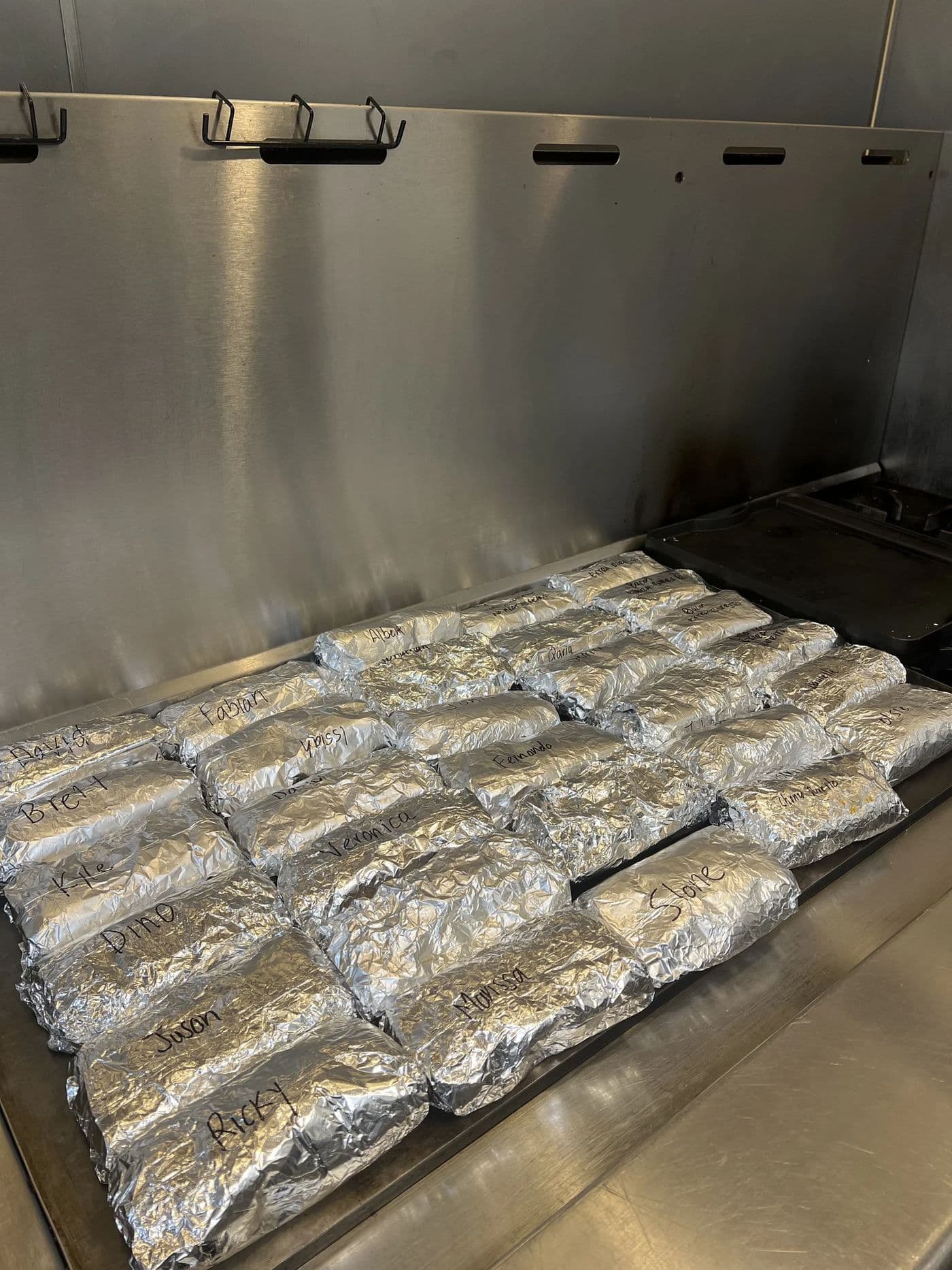 Tray of foil-wrapped burritos prepared for a Las Vegas corporate lunch