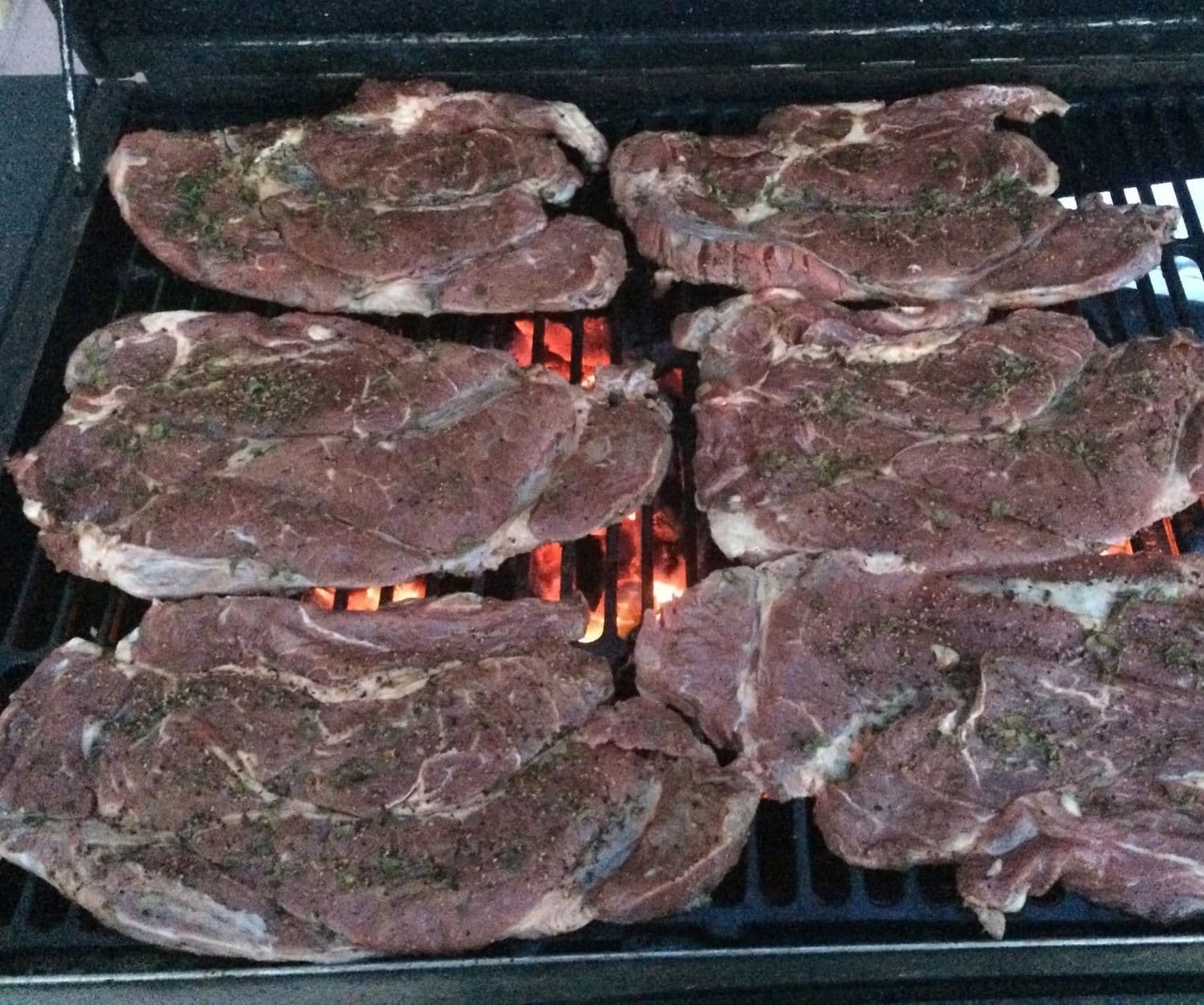 Carne asada over live mesquite fire at a Chicali Tacos event